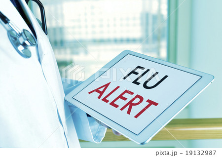 doctor with a tablet with the text flu alert 19132987