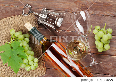 Bunch of grapes, white wine and corkscrew 19133659