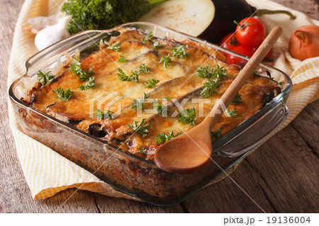 Greek moussaka closeup in baking dish 19136004