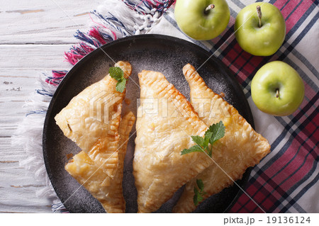 Delicious homemade apple pie turnover closeup Delicious homemade apple pie turnover closeup 19136124