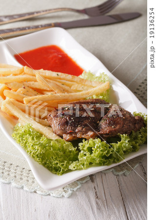 Hot beef steak with french fries and ketchup 19136254