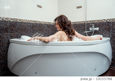 Brunette taking bath with her back to camera Brunette taking bath with her back to camera 19155766