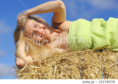 beautiful young blond lying on the grass yellow 19158036