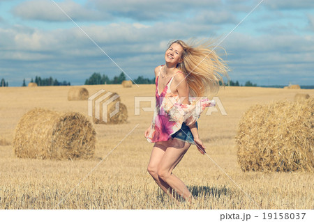 beautiful blonde jumps in sloping field sun happiness beautiful blonde jumps in sloping field sun happiness 19158037