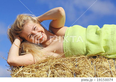 beautiful young blond lying on the grass yellow 19158074