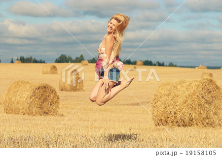 beautiful blonde jumps in sloping field sun happiness beautiful blonde jumps in sloping field sun happiness 19158105