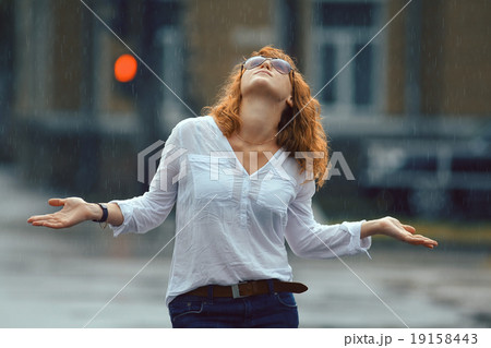 Portrait of red-haired happy woman in the rain Portrait of red-haired happy woman in the rain 19158443