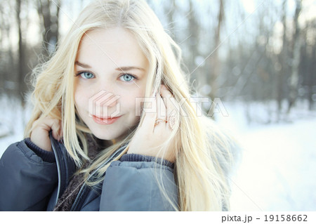 portrait of a young blonde girl in winter forest in the park portrait of a young blonde girl in winter forest in the park 19158662