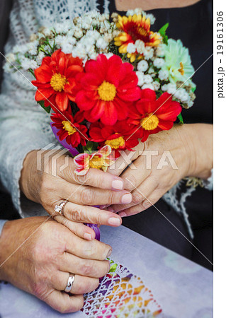 hands in close-up shot rings flowers elderly 19161306
