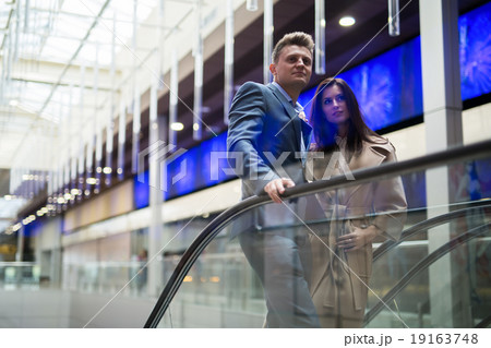 Woman in trench coat and a man 19163748