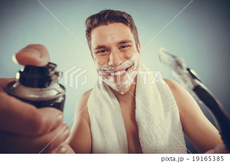 Handsome man with shaving cream foam can and razor Handsome man with shaving cream foam can and razor 19165385