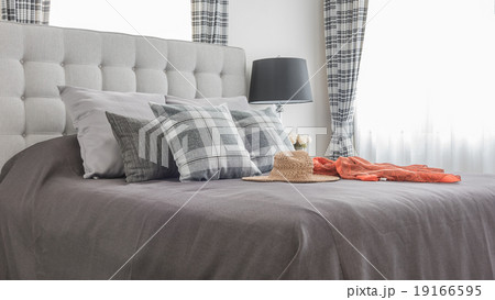 bed with pillows, hat, cloth and black lamp 19166595