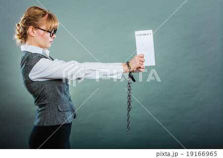 businesswoman with chained hands holding contract businesswoman with chained hands holding contract 19166965