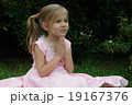 Small girl with hands folded. 19167376
