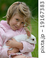 Small girl and the white rabbit. 19167383