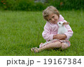 Small girl and the white rabbit. 19167384