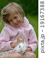 Small girl and the white rabbit. 19167388