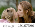 Girl and mom are kissing. 19167390
