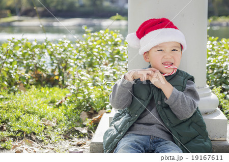 Cute Mixed Race Boy With Santa Hat and Candy Cane Cute Mixed Race Boy With Santa Hat and Candy Cane 19167611