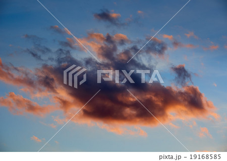 one big sunset cloud, dark colorful object on sky 19168585