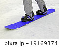 sportsman with blue snowboard on white snow. 19169374