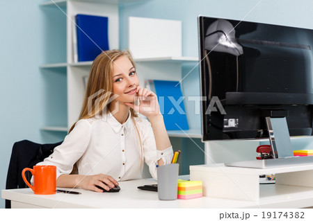 Woman sitting at the desk with computer Woman sitting at the desk with computer 19174382