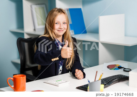 Little girl like business woman at the table Little girl like business woman at the table 19174668