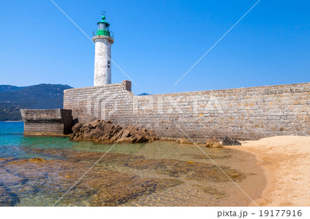 White stone lighthouse tower on the pier. Corsica White stone lighthouse tower on the pier. Corsica 19177916
