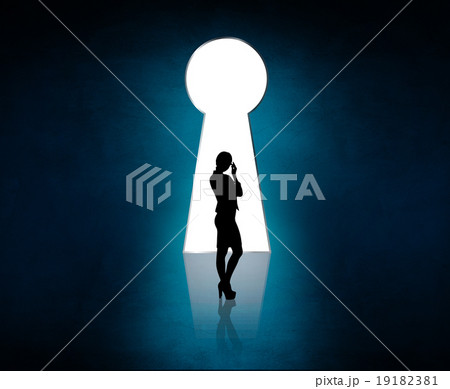 Silhouette stands near big keyhole exit.  19182381