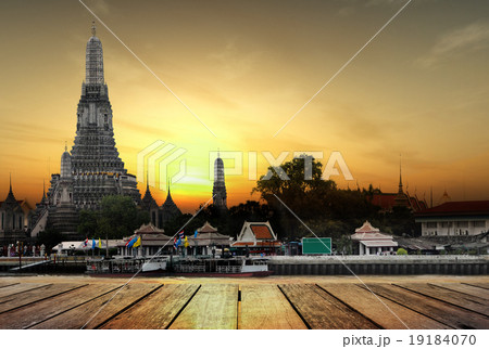 Concept, wat arun in sunset and wood planks floor 19184070