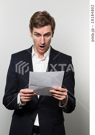 studio shot of businessman with sheet of paper 19184802