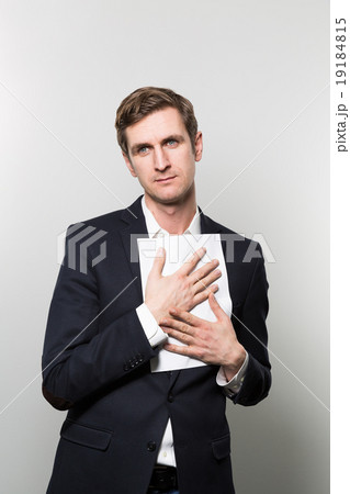 studio shot of businessman with sheet of paper 19184815