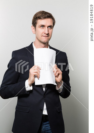 studio shot of businessman with sheet of paper 19184819