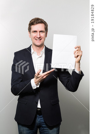 studio shot of businessman with sheet of paper studio shot of businessman with sheet of paper 19184829