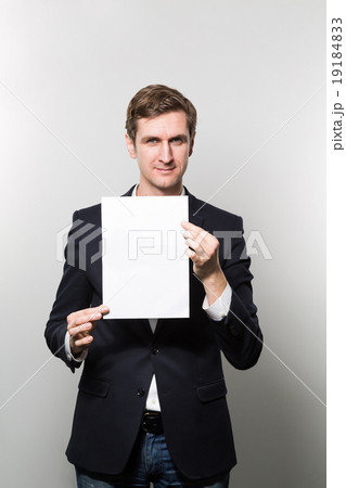 studio shot of businessman with sheet of paper studio shot of businessman with sheet of paper 19184833