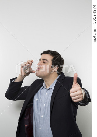 studio shot of happy businessman drinking water studio shot of happy businessman drinking water 19184874