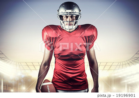 Composite image of portrait of american football player holding 19196901