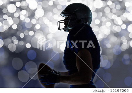 Composite image of side view of sportsman holding football Composite image of side view of sportsman holding football 19197006
