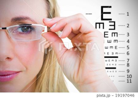 Composite image of close up of pretty blonde with reading glasse Composite image of close up of pretty blonde with reading glasse 19197046