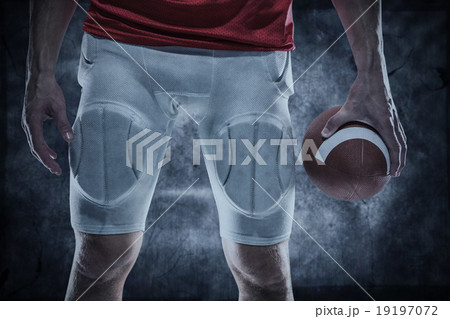 Composite image of sports player holding ball Composite image of sports player holding ball 19197072