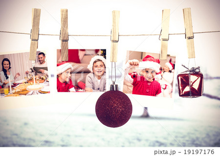 Composite image of hanging christmas photos 19197176