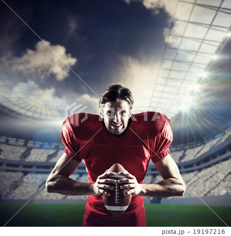 Composite image of aggressive american football player in red je 19197216