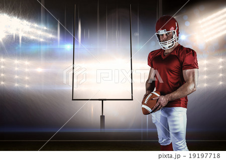 Composite image of american football player holding ball Composite image of american football player holding ball 19197718