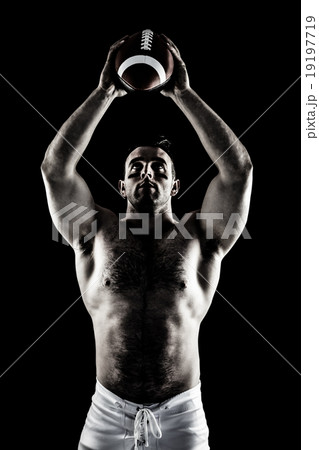 Composite image of shirtless american football player with ball 19197719