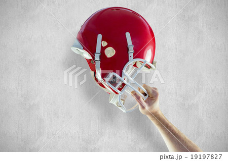 Composite image of american football player holding up his helme 19197827