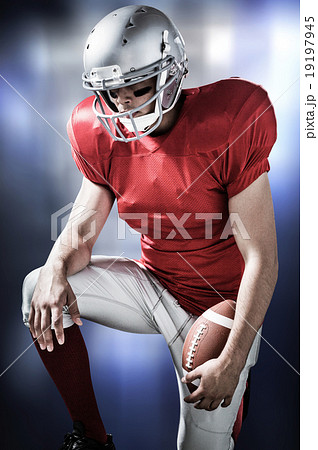 Composite image of american football player with hand on knee 19197945