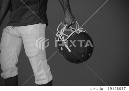 Composite image of midsection of player holding rugby helmet 19198057