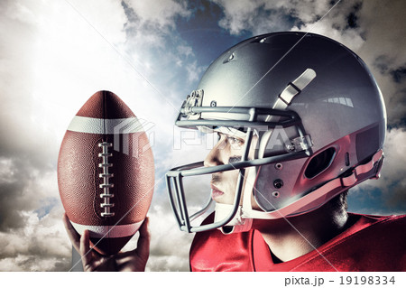 Composite image of confident sportsman looking away while holdin Composite image of confident sportsman looking away while holdin 19198334