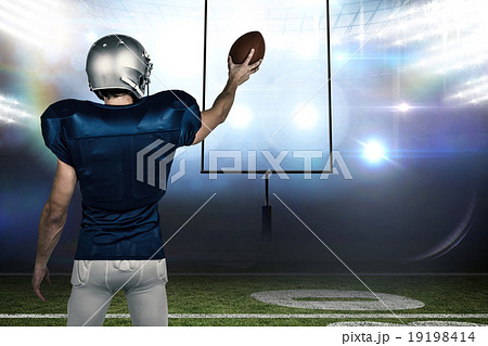 Composite image of rear view of sports player holding ball Composite image of rear view of sports player holding ball 19198414