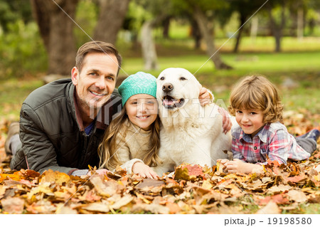 Smiling young family with dog 19198580